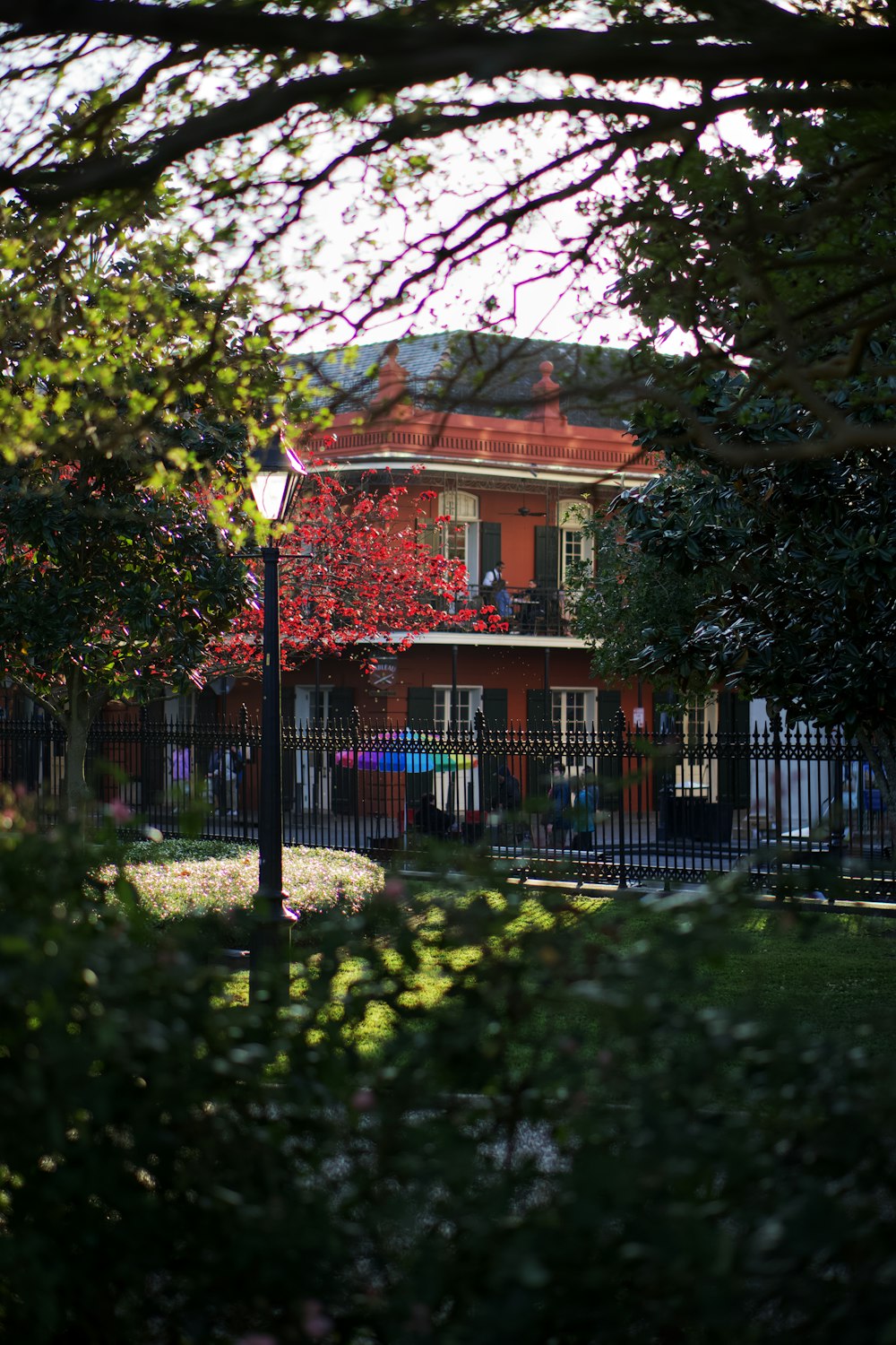 a red brick house with a black fence