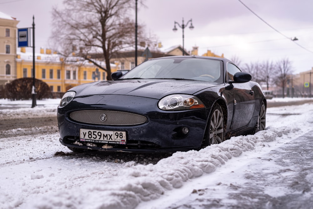 a car parked on the side of a snowy road