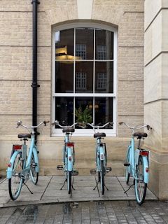 a couple of bikes parked in front of a window