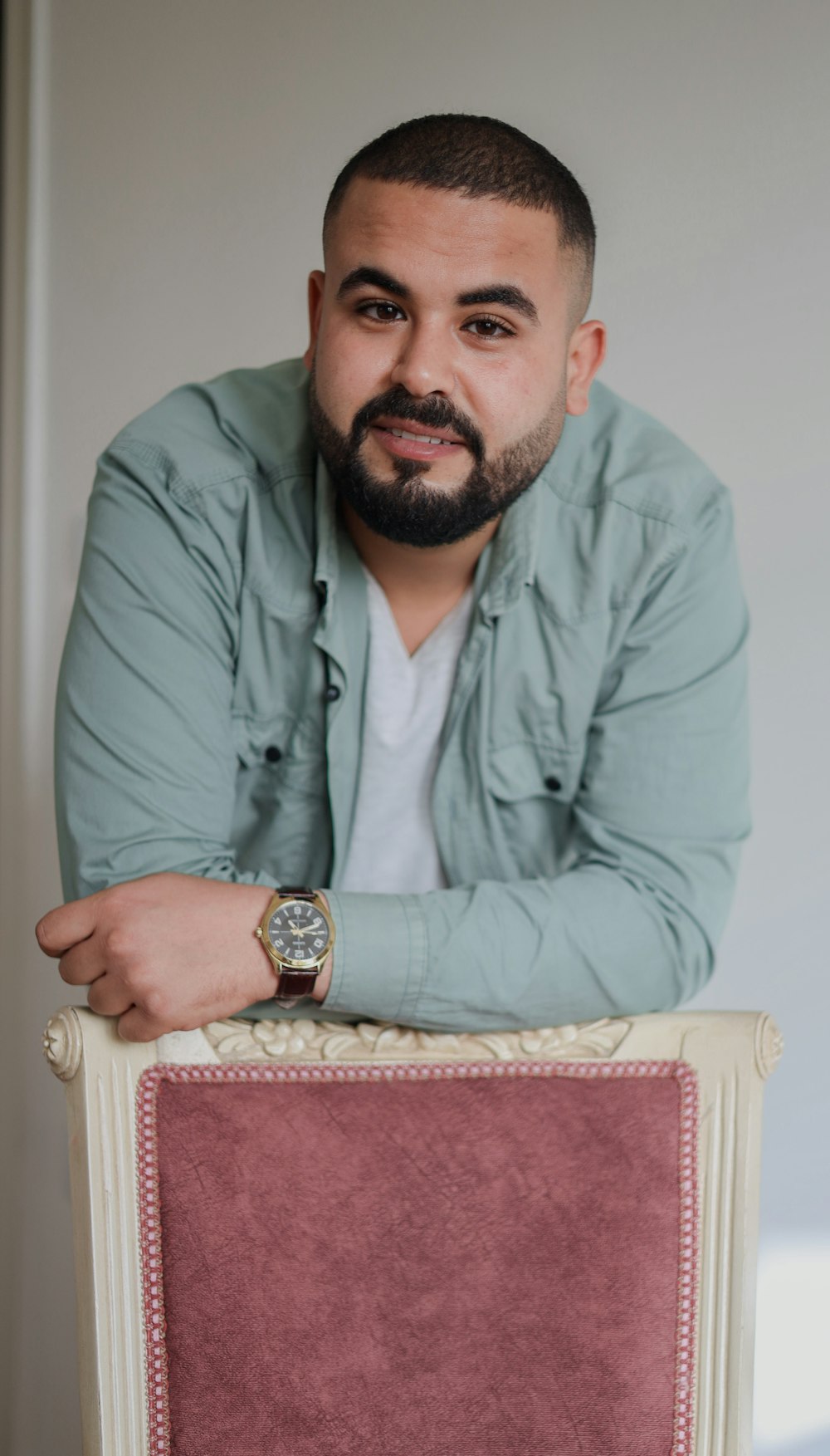 a man with a beard sitting on a chair