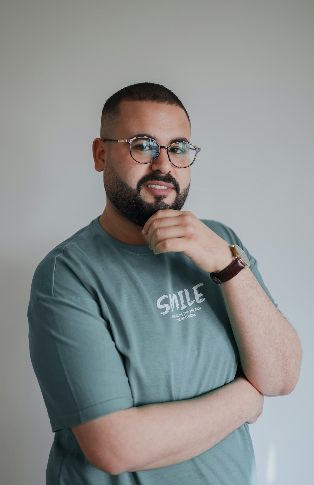 a man with glasses is posing for a picture