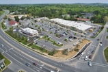 Wide-angle shot of a retail park with multiple stores and landscaped areas.