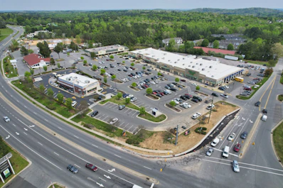 A panoramic view of a commercial plot near main roads with clear signage.