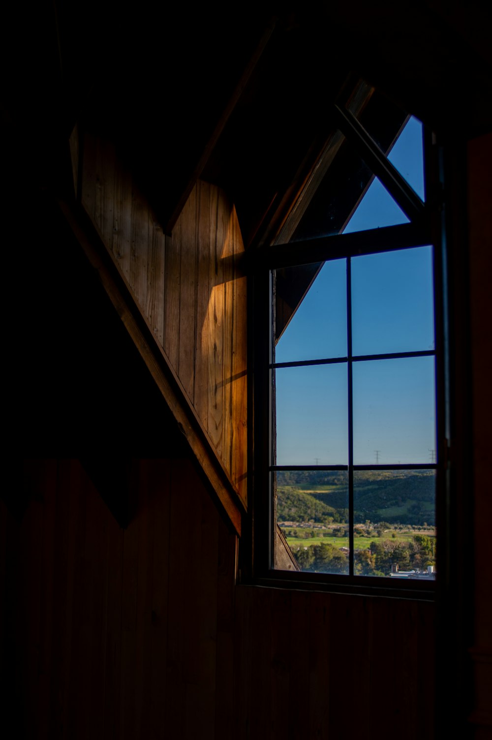 a window with a view of a valley outside of it