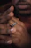 Close-up of a hand wearing a sleek, calming stress relief ring against a soft, blurred background.