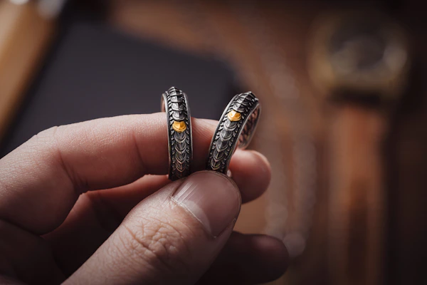 Close-up of elegant 925 sterling silver rings with intricate designs.