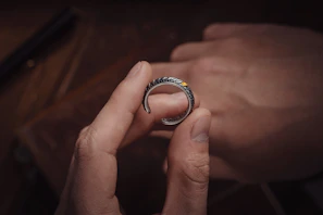 Artisan crafting a fine ring with gentle hands and natural light