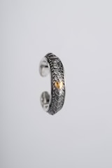 Close-up of a delicate AI-generated gold ring with intricate geometric patterns.