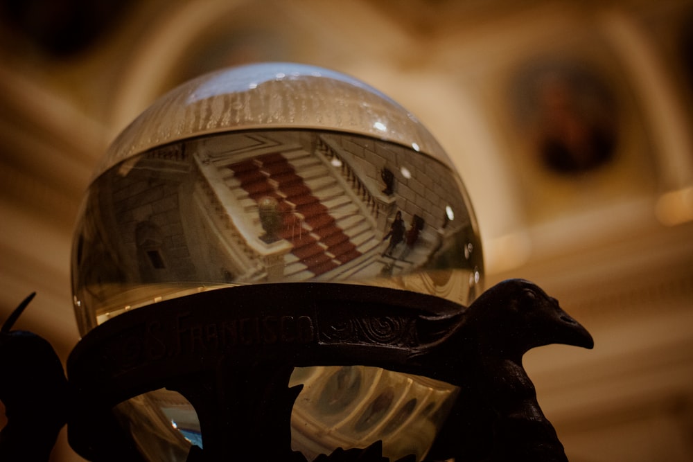 a glass ball sitting on top of a metal stand