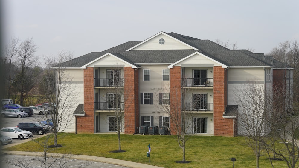 an apartment building with cars parked in front of it