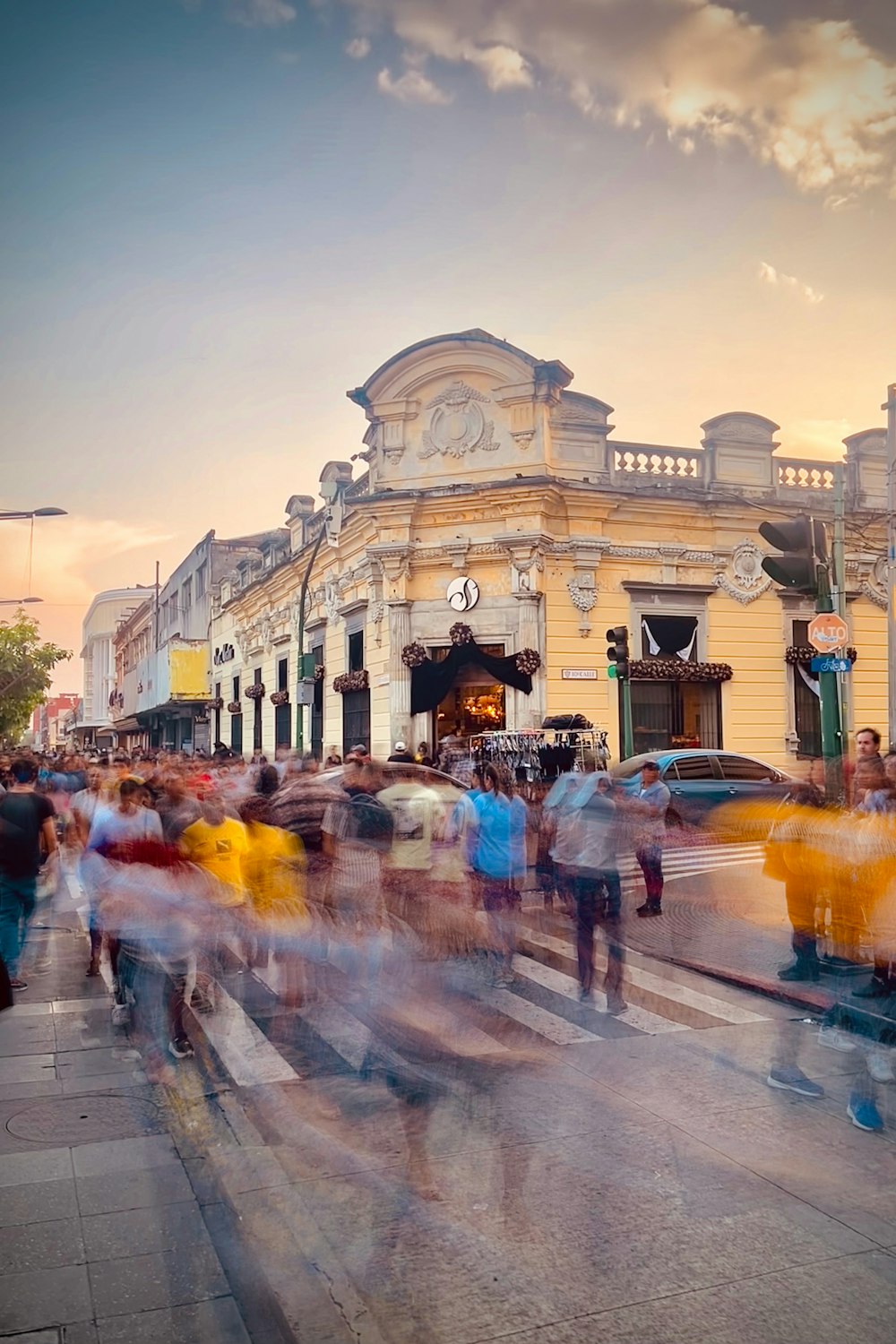 a crowd of people walking down a street next to a building