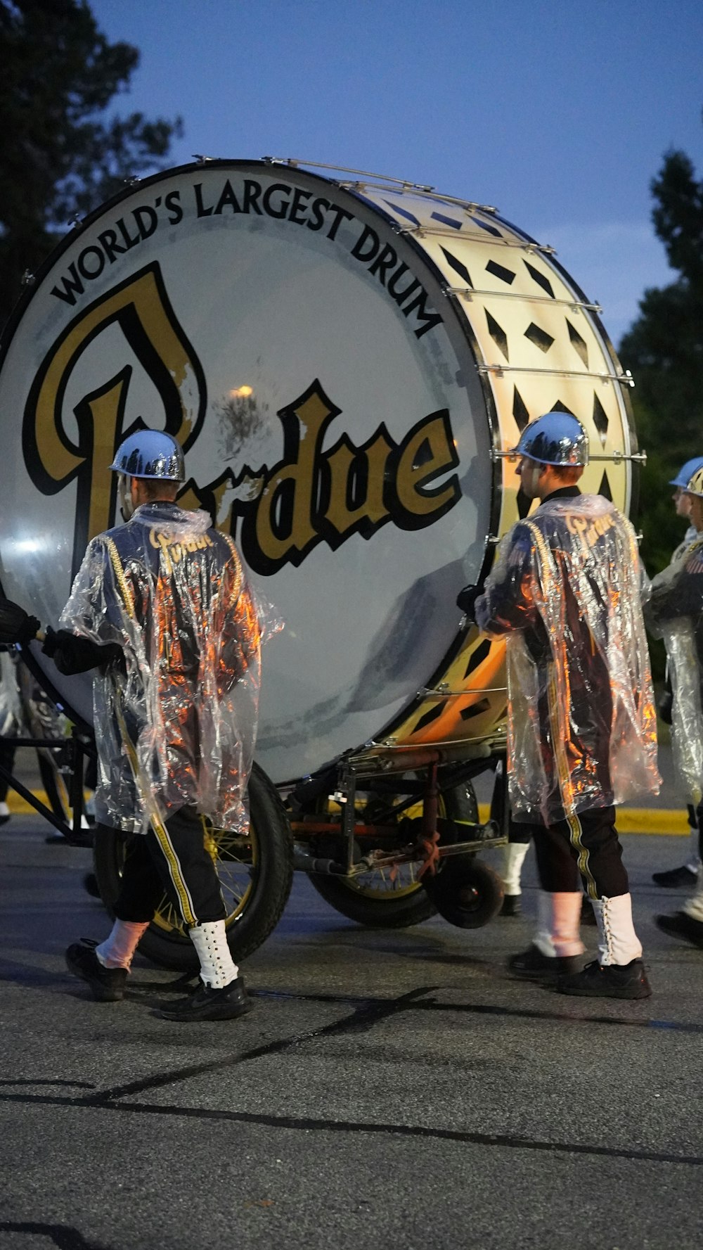 a group of people standing around a large drum