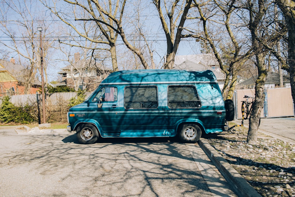 a blue van parked on the side of the road