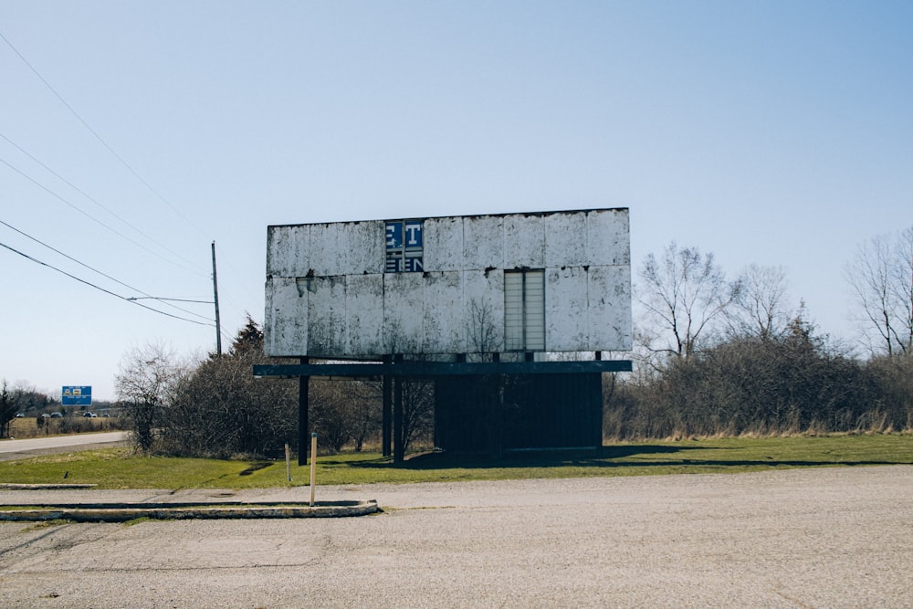 a large billboard sitting on the side of a road