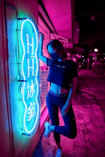 Vibrant streetwear outfit glowing under neon lights on a city rooftop at night