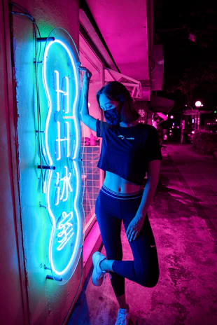A dynamic urban street scene at night with a young person wearing neon-accented streetwear, embodying the edgy vibe of urbanpulse.