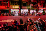 A vibrant street scene in Vietnam, alive with colorful scooters and warm afternoon light.