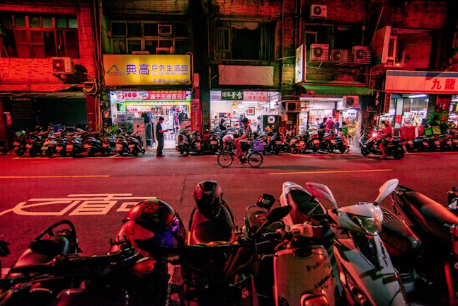 A vibrant street scene with bikes and scooters parked.