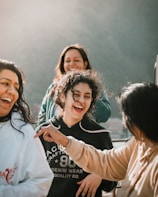 A cheerful group of friends laughing together during a nature hike.