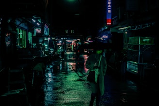 A character from a cyberpunk game standing under a rain-soaked neon sign in a dark alley.