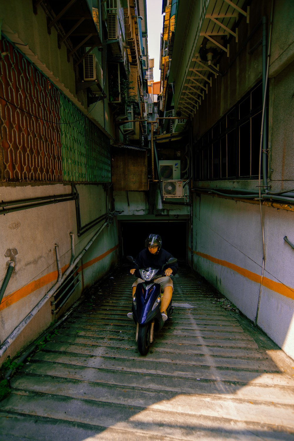 a man riding a motorcycle down a tunnel