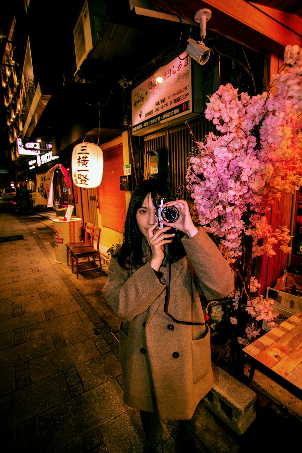 a woman taking a picture of herself with a camera