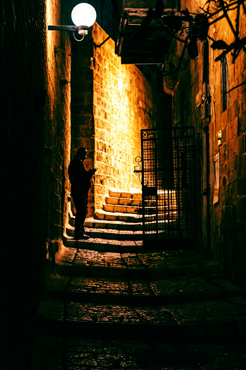 a person walking down a dark alley way