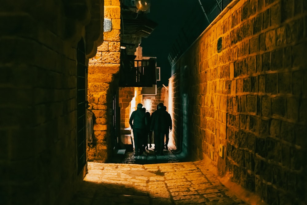 two men walking down a narrow alley way