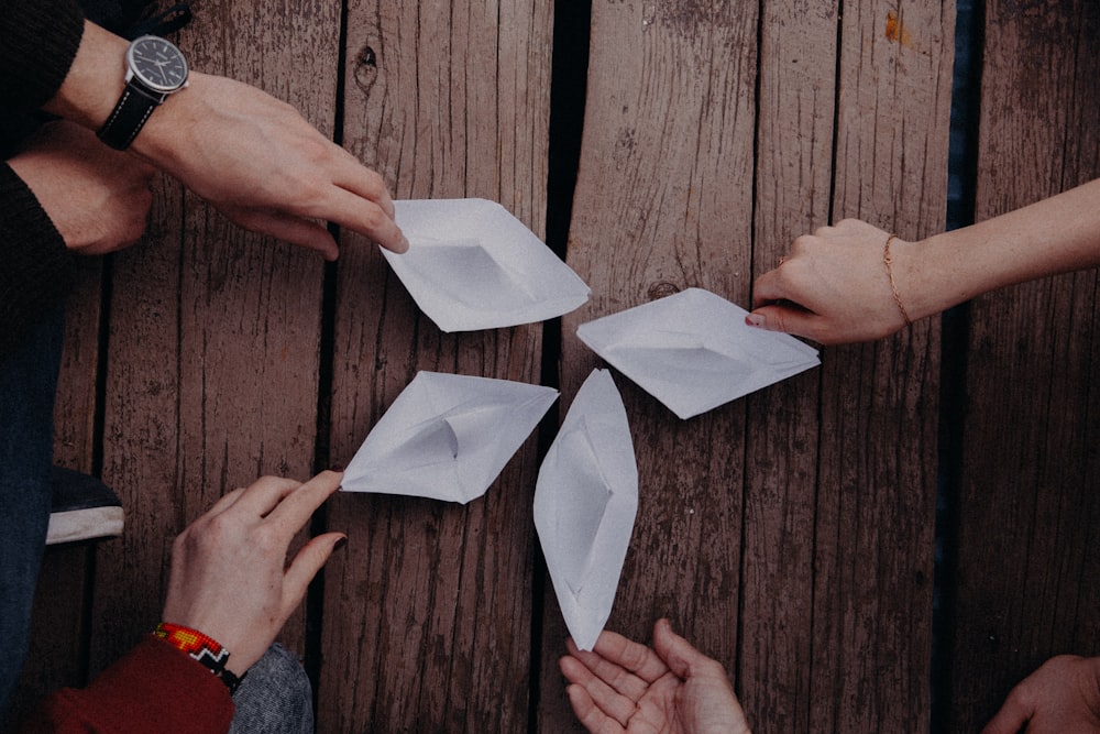 a group of people holding origami pieces of paper