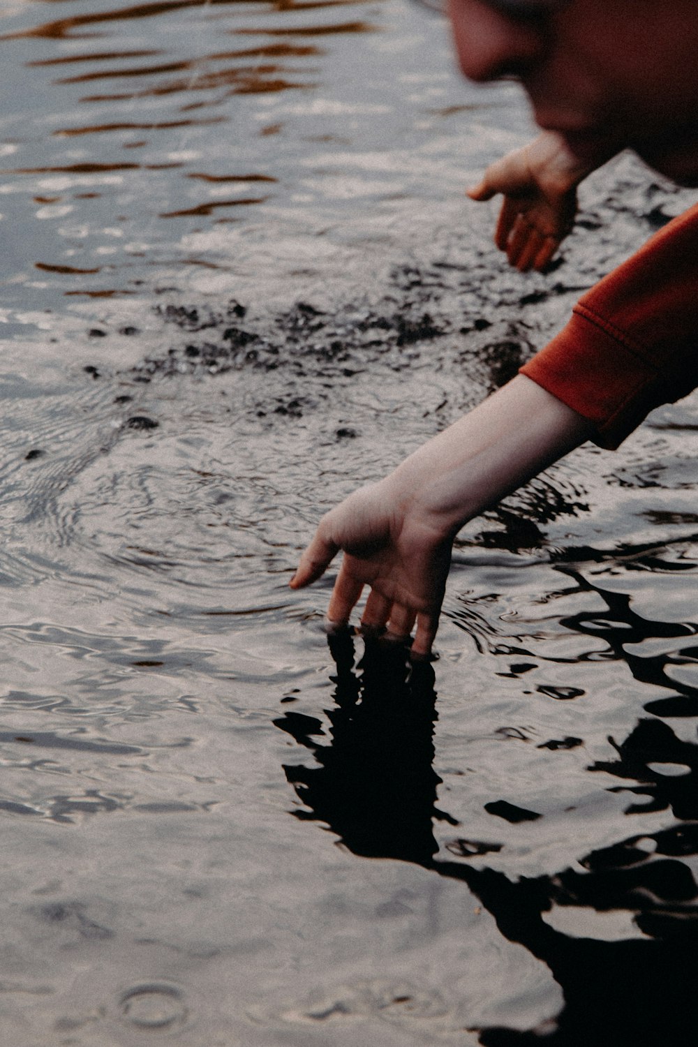 a person reaching for something in the water