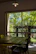 Guests enjoying breakfast in a bright garden surrounded by natural wood decor.