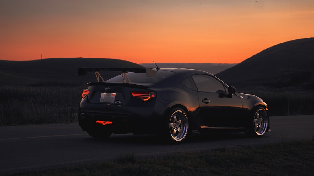 a black sports car parked on the side of the road