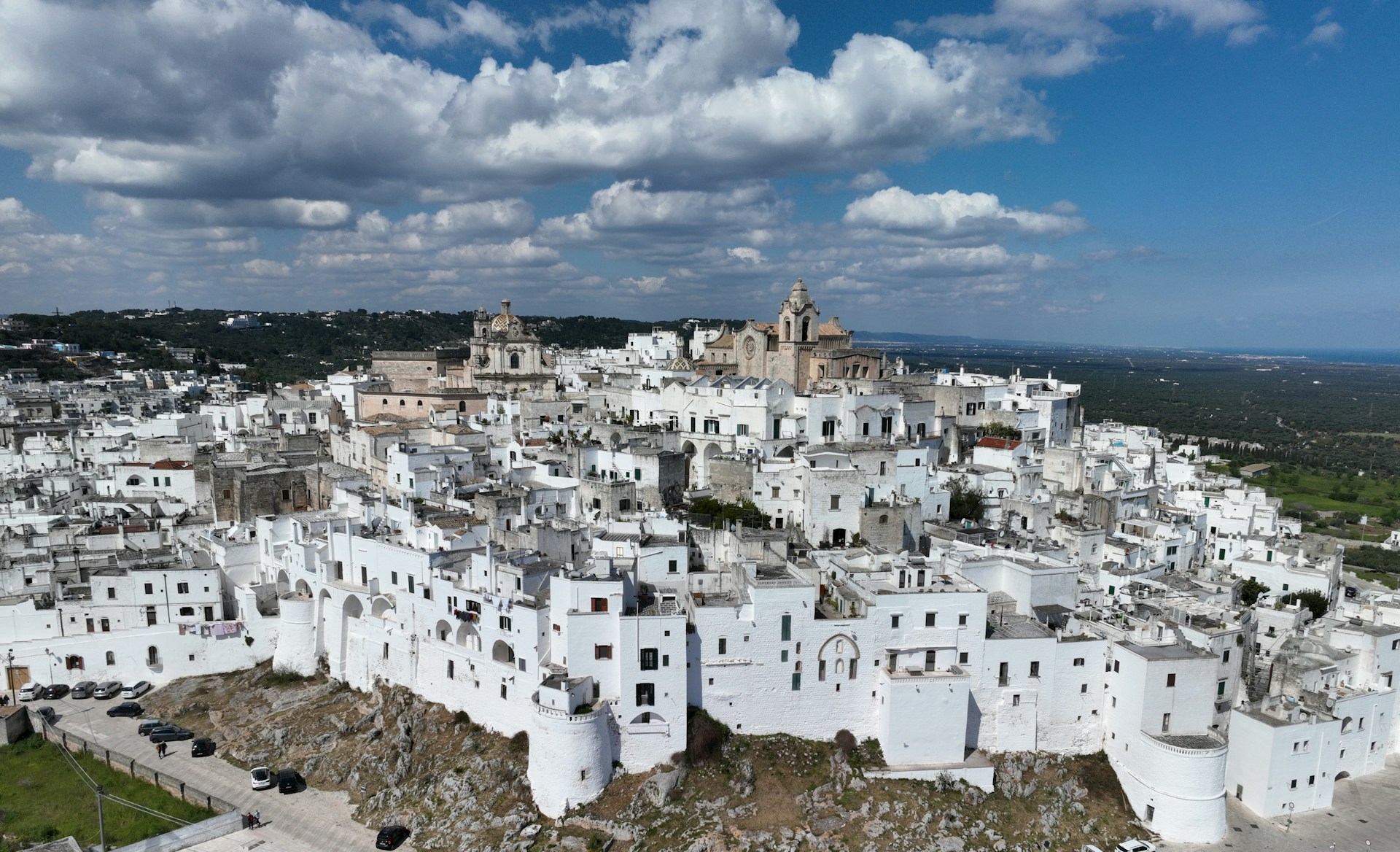 an aerial view of a city with white buildings
