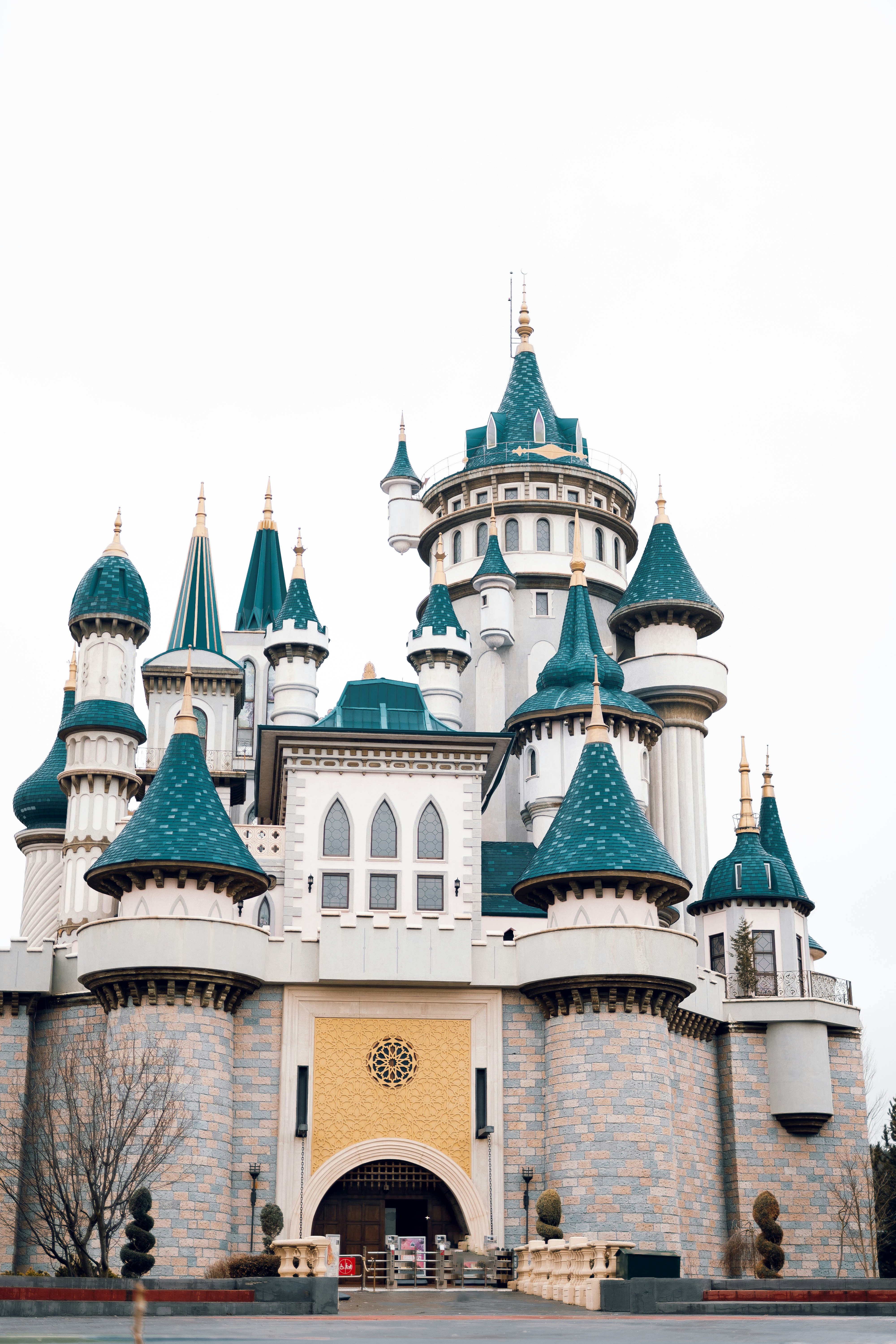A castle with a clock on the front of it photo – Free Building Image on ...