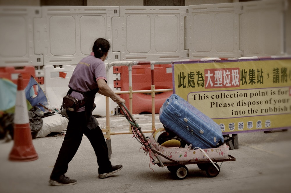a person pulling a cart with luggage on it