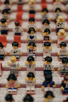 Vintage LEGO sets stacked neatly with some minifigures in front.