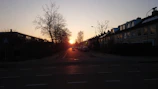 A peaceful neighborhood street at sunset, evoking new beginnings.