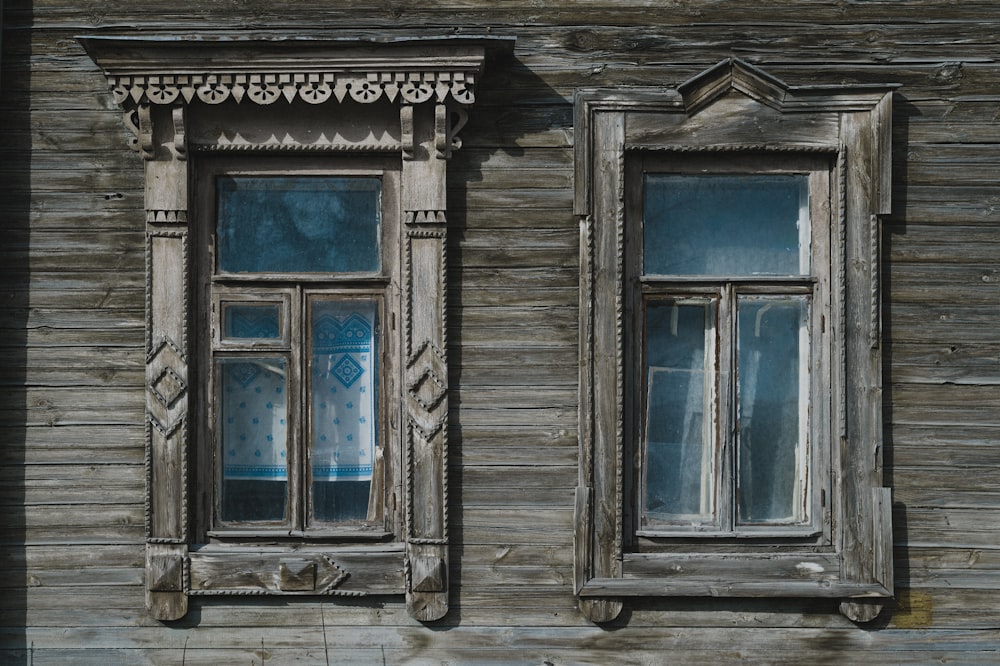 an old wooden building with two windows