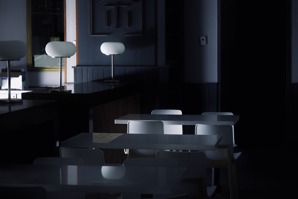 a dimly lit room with tables and chairs