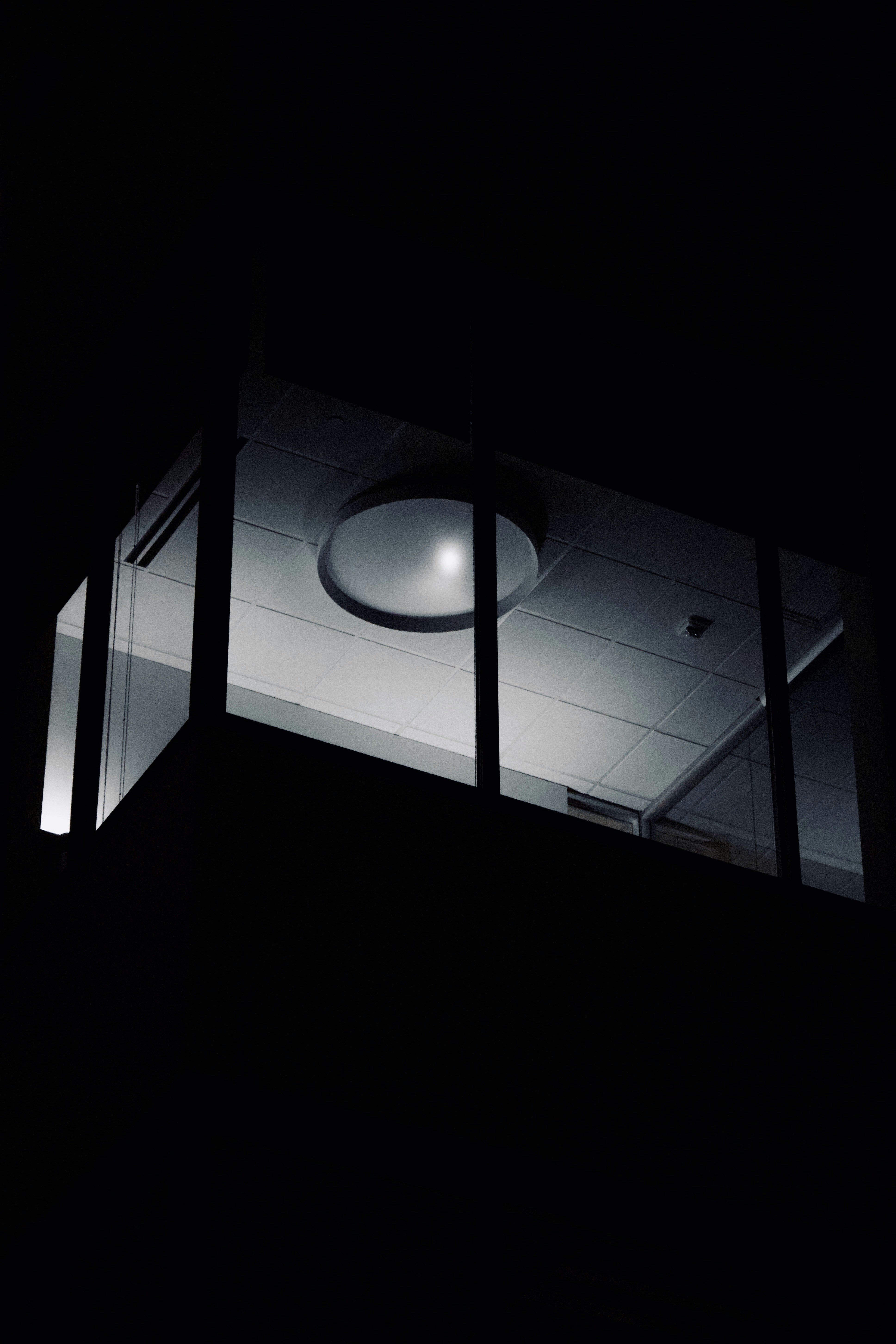 a black and white photo of a ceiling light