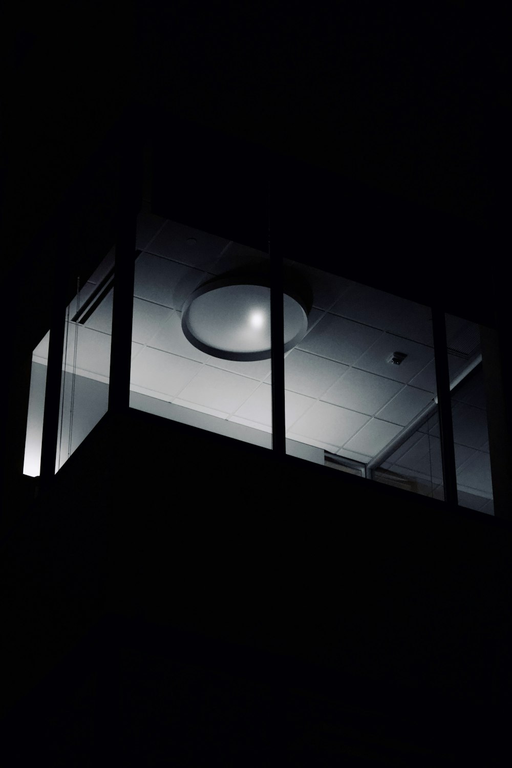 a black and white photo of a ceiling light