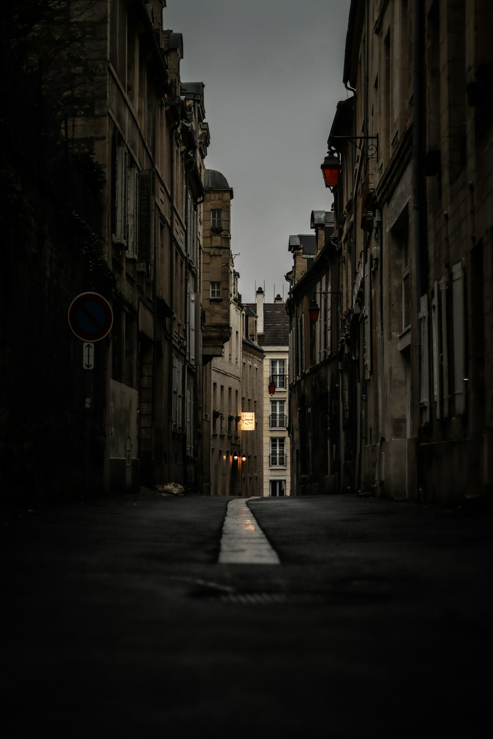 an empty street with a dark sky in the background