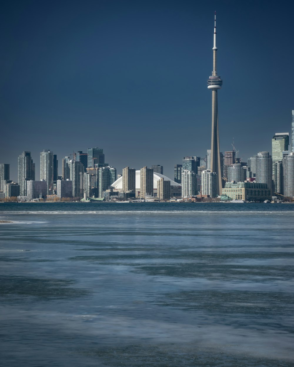 a large body of water with a city in the background