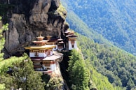 A serene monastery perched on a cliff, surrounded by stunning natural scenery.