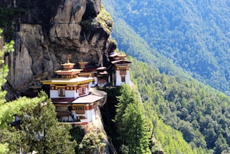 A serene monastery perched on a cliff, surrounded by stunning natural scenery.