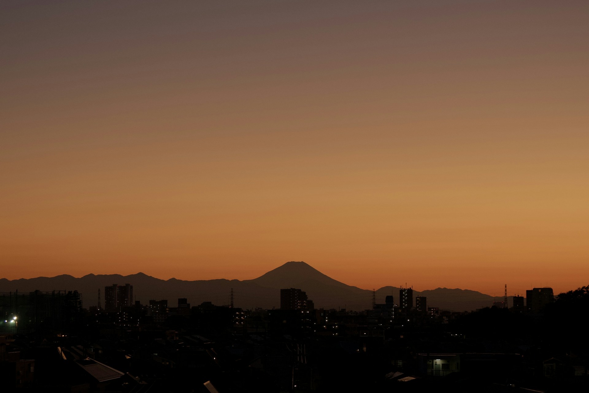A scenic view of Japan’s cityscape at dusk featured behind a subtle parallax effect, highlighting the opportunity awaiting in the internship.