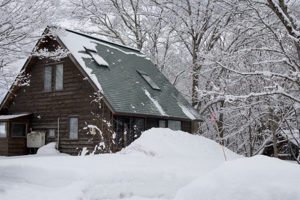 a house in the woods covered in snow