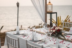 a table set for a wedding with a view of the ocean