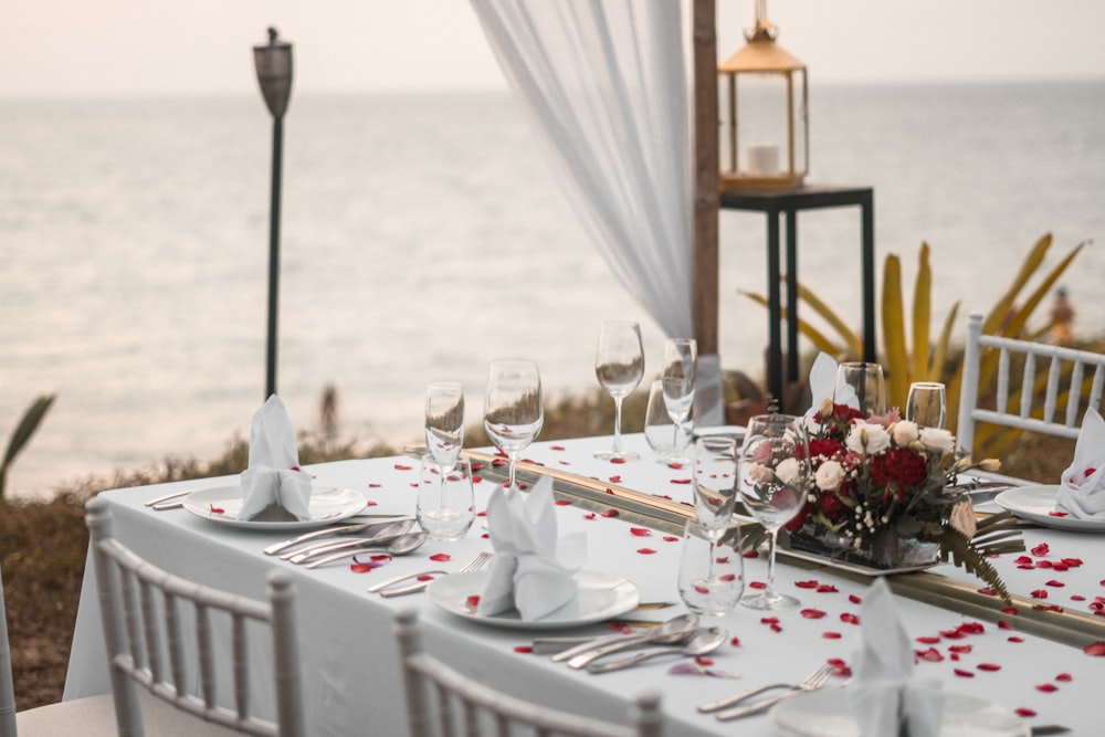 a table set for a wedding with a view of the ocean