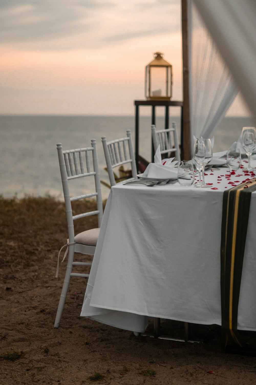 a table set up for a wedding with a view of the ocean